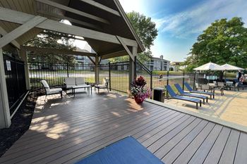 A large deck with chairs and a gazebo